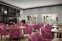 a room with purple chairs and tables and a fireplace at Hilton Garden Inn Jacksonville Downtown Southbank in Jacksonville