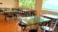 a row of tables and chairs in a room at ISOL Nature Resort in Rishīkesh