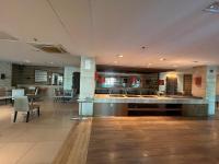 a lobby with tables and chairs in a building at Flat na Beira do Lago in Brasilia