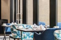 a dining room with blue chairs and a table at Mercure Riyadh Al Anoud in Riyadh