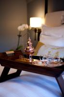 a tray with a tea pot on a table next to a bed at The Gainsborough Bath Spa - Small Luxury Hotels of the World in Bath