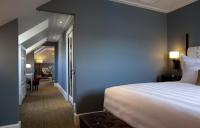 a hotel room with a large bed and a hallway at The Gainsborough Bath Spa - Small Luxury Hotels of the World in Bath