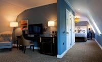 a hotel room with a desk and a bed and a bedroom at The Gainsborough Bath Spa - Small Luxury Hotels of the World in Bath