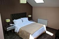 A bed or beds in a room at Vienna Suites