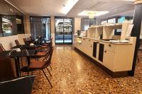 a kitchen and dining room with a table and chairs at Albergo San Marco in Venice
