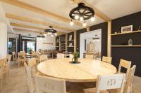 a dining room with a wooden table and chairs at RHOLL Pension & Restaurant in Hámry