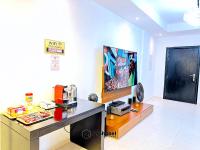 ein Wohnzimmer mit einem Schreibtisch und einem TV in der Unterkunft Stylish 3-bedroom plus Maid room - Villa in JVC - Dubai in Dubai