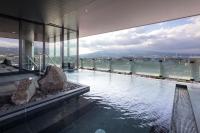 a swimming pool in a building with a view at Tokyu Vacations Fujisan Mishima in Mishima