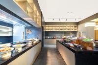 a restaurant kitchen with a buffet line with food at Atour Hotel Suzhou Beisi Pagoda Taohuawu Street in Suzhou