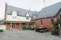 ティマルにあるKingsdown Manor B&amp;B Timaruのレンガ造りの建物で、中庭にピクニックテーブルがあります。