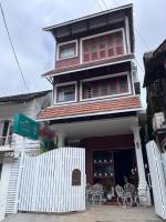 a building with tables and chairs in front of it at The Lilly's Stories in Fort Kochi