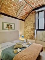 A bed or beds in a room at Casa Adua by TraMonti Apartments