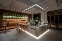 a restaurant with a bar with a table and chairs at Guizhou Kaili Leli Designer Hotel in Bainiu