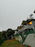 a large apartment building with stairs in front of it at The Autumn by Maat Hotels in Vagamon