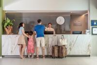 a group of people standing around a counter at Porto Kaeté Hotel in Maceió