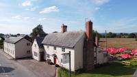 an aerial view of a white building with red roofs at The Red Lion, Madley in Hereford