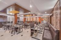 a dining room with tables and chairs at Park Avenue Hotel & Apartments Trichy in Tiruchchirāppalli
