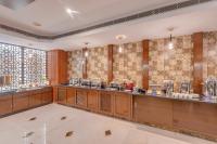 a restaurant with a counter in a room at Park Avenue Hotel & Apartments Trichy in Tiruchchirāppalli