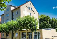 a building with a sign on the side of it at Hotel Post in Weiden