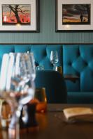 a restaurant with a table and a blue couch at Coach & Horses Dersingham in Dersingham