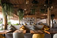 a restaurant with couches and tables in a room at The Deck Cottages Samui in Bophut 