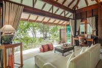 a living room with a couch and a table at Koh Jum Beach Villas "A member of Secret Retreats" in Ko Jum