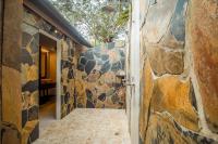 a hallway with a stone wall and an open door at Koh Jum Beach Villas "A member of Secret Retreats" in Ko Jum