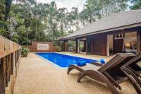a villa with a swimming pool and a house at Koh Jum Beach Villas "A member of Secret Retreats" in Ko Jum