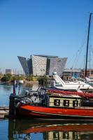 a red boat is docked in a marina at Ramada by Wyndham Belfast in Belfast
