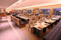 a restaurant with tables and chairs in a room at Wingate by Wyndham Libo Center in Libo