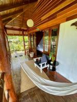 a hammock in the living room of a house at Oon Lee Bungalows in Ko Jum