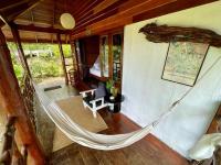 a hammock in a room with a bedroom at Oon Lee Bungalows in Ko Jum