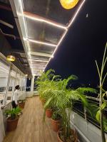 a person standing in an office with plants on the floor at HOTEL MAA LAXMI PALACE in Deoghar
