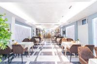 a restaurant with tables and chairs and windows at Safir Hotel in Akaryk