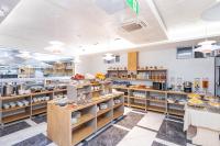 a kitchen with shelves of food in a restaurant at Safir Hotel in Akaryk