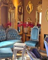a living room with blue chairs and mirrors at Hyde Hill Kosmaj in Sopot