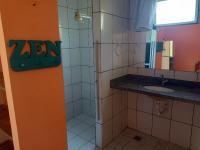 a bathroom with a shower and a sink at Pousada ZEN Cumuruxatiba in Cumuruxatiba