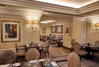 a restaurant with tables and chairs in a room at The Royal Horseguards Hotel, London in London