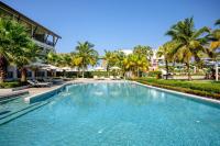 a swimming pool with palm trees in a resort at Katathani Phuket Beach Resort - SHA Extra Plus in Kata Beach