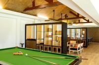 a room with a pool table and a dining room at Katathani Phuket Beach Resort - SHA Extra Plus in Kata Beach