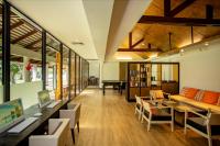 a living room with a couch and a table at Katathani Phuket Beach Resort - SHA Extra Plus in Kata Beach