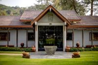 a house with a fountain in the middle of a yard at Katathani Phuket Beach Resort - SHA Extra Plus in Kata Beach