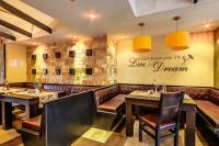 un restaurant avec des tables et des chaises et un panneau sur le mur dans l'établissement Dream Private Apartment N511, à Bansko