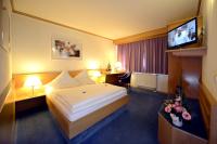 a hotel room with a bed and a flat screen tv at Hotel Bavaria Brehna in Brehna