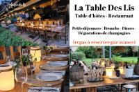 a table set up for a dinner party with wine glasses at Au Gré Des Lis - La Suite Du Chêne in Belval-sous-Châtillon