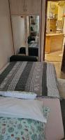 A bed or beds in a room at ANNA GYÖNGYE APARTMAN DEBRECEN