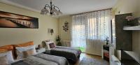 A bed or beds in a room at ANNA GYÖNGYE APARTMAN DEBRECEN
