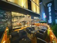 a restaurant with couches and tables in front of a building at HOTEL SUI AKASAKA by ABEST in Tokyo