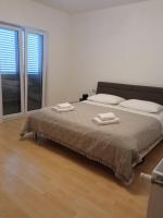 Łóżko lub łóżka w pokoju w obiekcie Apartman Carpe Diem