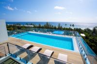 a swimming pool with a view of the ocean at Ocean Pearl Fuvahmulah in Fuvahmulah